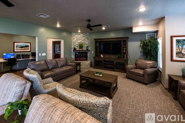 A living room with a stone wall and a flat screen TV.