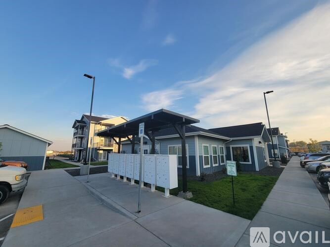 A parking lot with a building in the background and a sign that says "AVAILABLE".