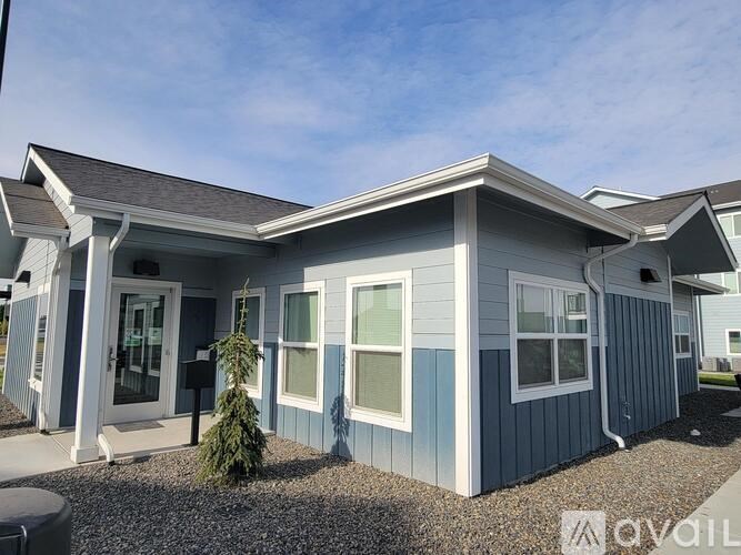 A small house with a porch and a front door.