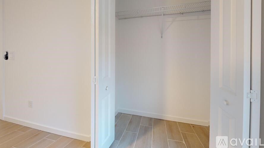 A room with a white door and a white wall.