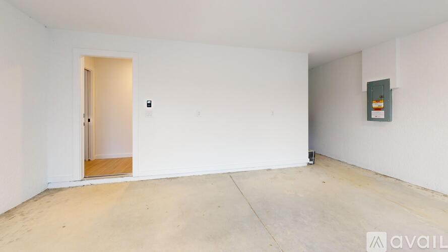 A room with a door and a wall-mounted light fixture.