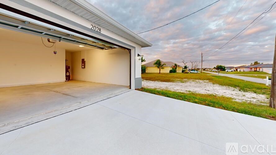 A garage with the number 2028 on the wall and a view of the outdoors.