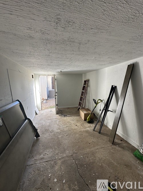 A room with a ladder and a window.