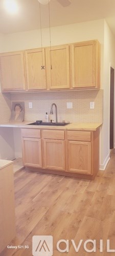 A kitchen with wooden cabinets and a white countertop.