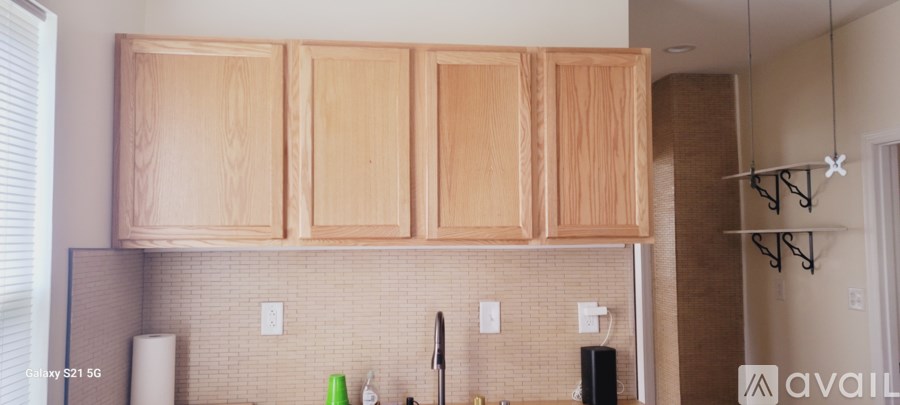 A kitchen with wooden cabinets and a white fridge.