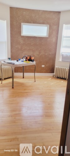 A room with a brown wall and a wooden floor.