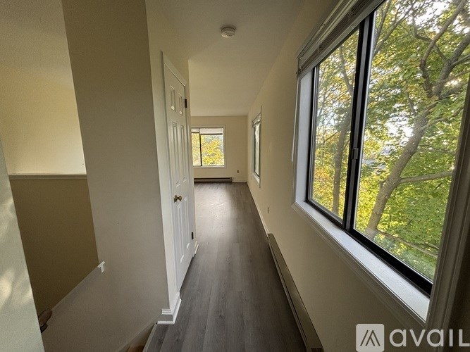 A hallway with a window on the right side.