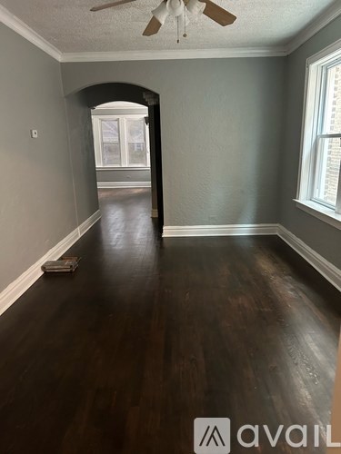 A room with a ceiling fan and a window.