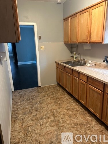 A kitchen with wooden cabinets and a sink.