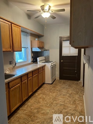 A kitchen with wooden cabinets and a white dishwasher.