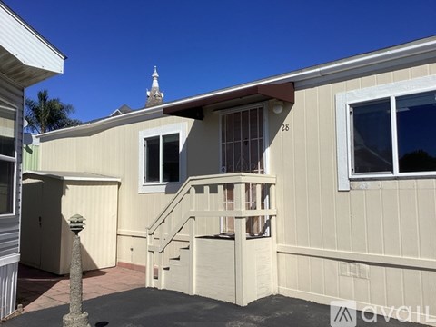 A house with a balcony and a small staircase leading to it.