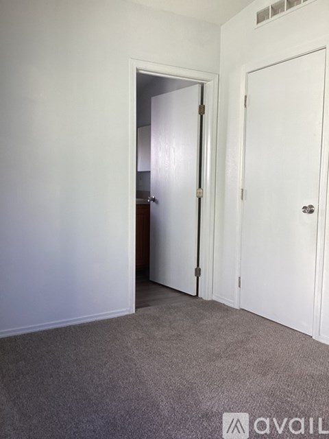 A room with two doors, one of which is open.