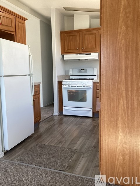 A kitchen with a white fridge and a white oven.