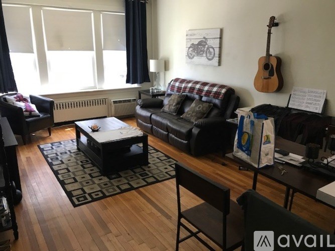 A living room with a guitar hanging on the wall.