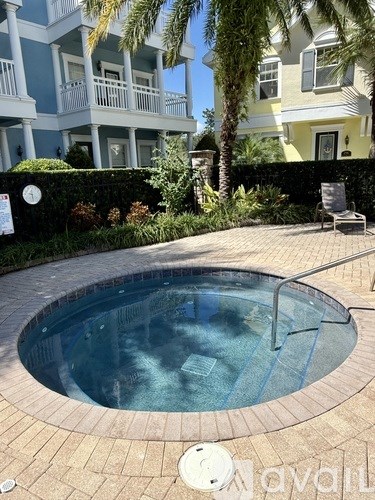 A round above ground pool with a tiled edge and a metal ladder.