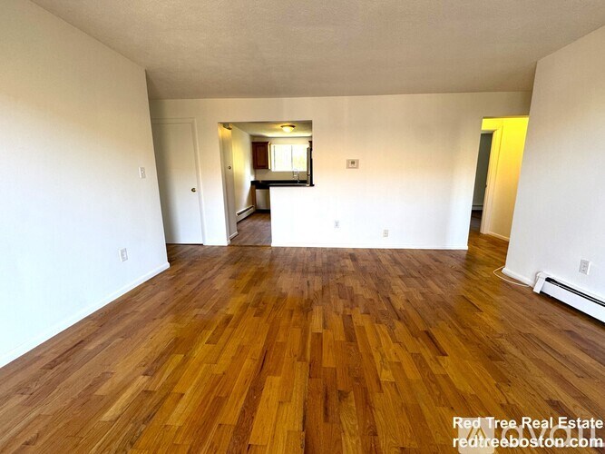 A room with wooden floors and white walls.