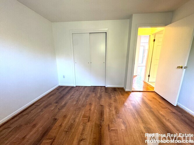 A room with wooden floors and a white door.