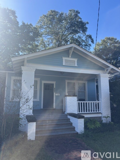 A small house with a porch and a front door.