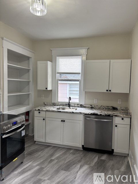 A kitchen with a stove, oven, and cabinets.