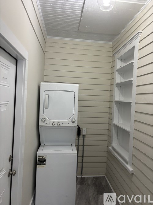 A white washing machine in a small room.