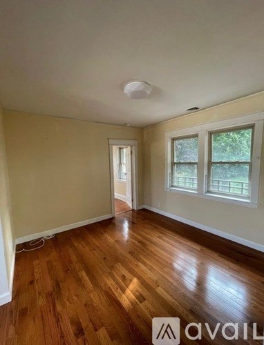 A room with wooden floors and a window.