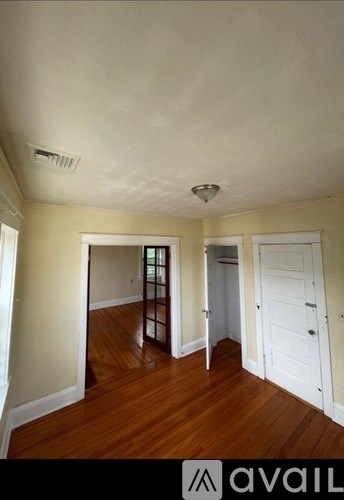 A room with wooden floors and white walls.