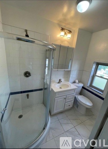 A bathroom with a white tub, sink, and toilet.
