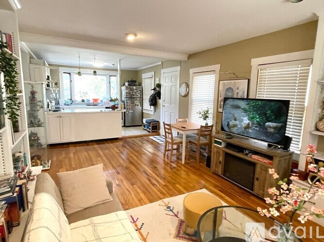 A living room with a television and a couch.