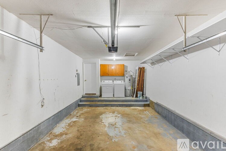 A room with a white wall and a brown floor.