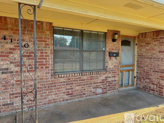 A house numbered 4130 with a blue door and window.