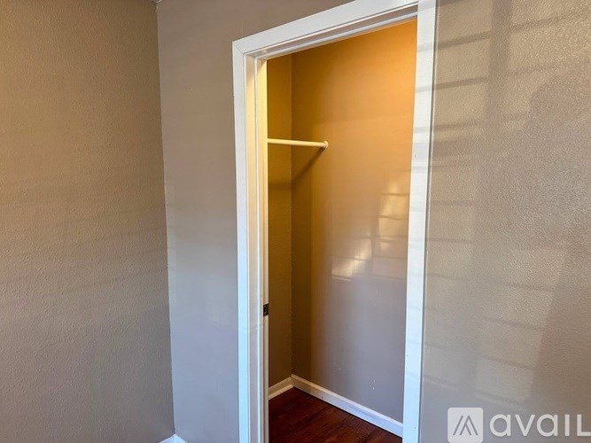 A white door with a glass window is open.