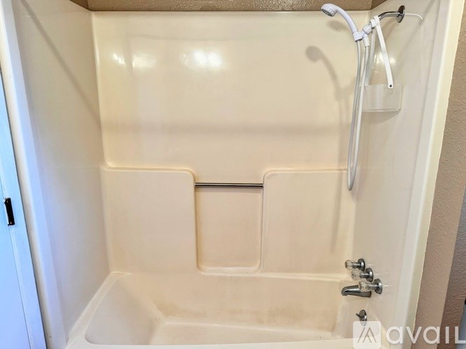 A white bathroom with a tub and shower.