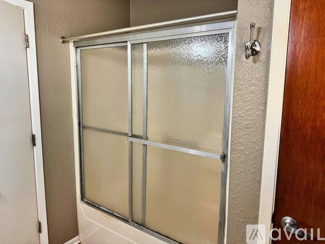 A frosted glass door with a handle and a lock.