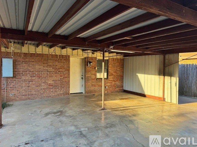 A room with a brick wall and a white door.