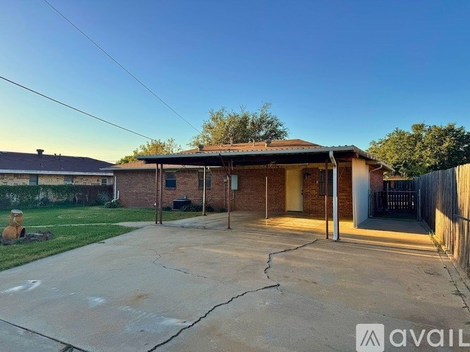 A house with a driveway in front of it is available for rent.
