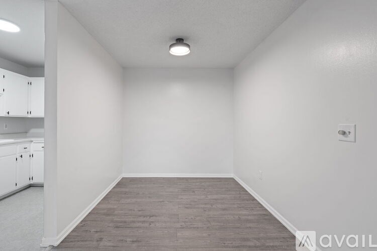 A room with a wooden floor and white walls.