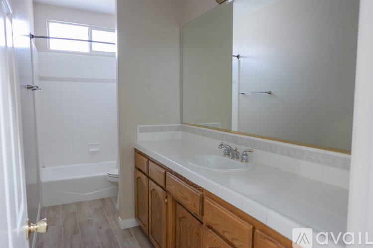 A bathroom with a white sink and a white tub.
