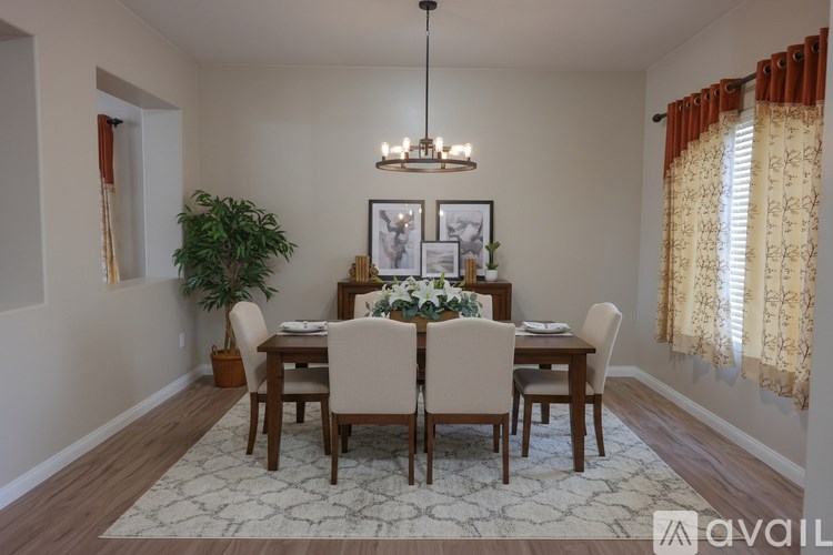 A dining room with a wooden table and chairs.