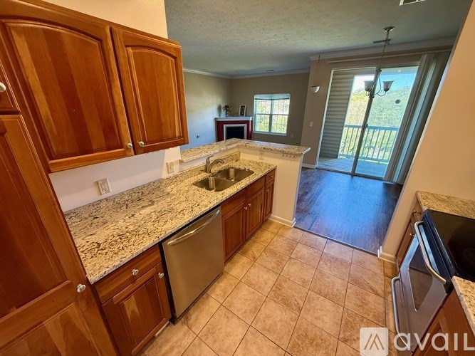 A kitchen with granite countertops and wooden cabinets.