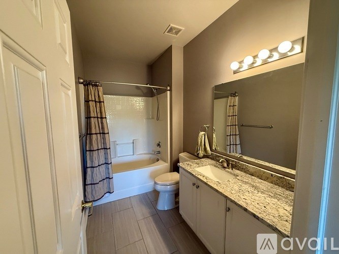 A bathroom with a toilet, sink, and shower.