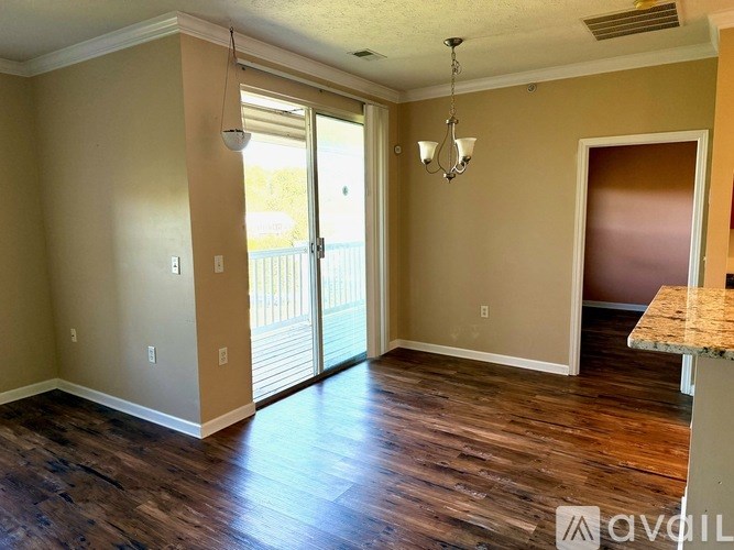 A room with wooden floors and a chandelier.