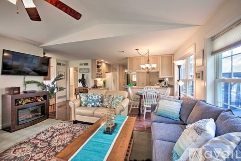 A living room with a grey couch and a wooden coffee table.