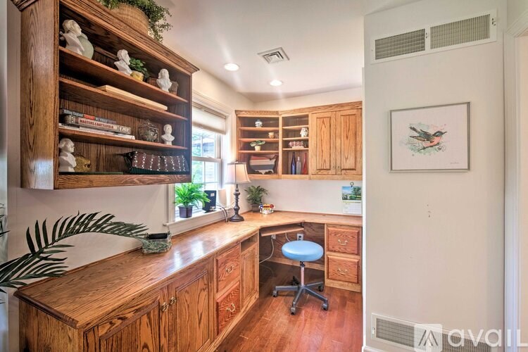 A kitchen with wooden cabinets and a countertop with a plant on it.