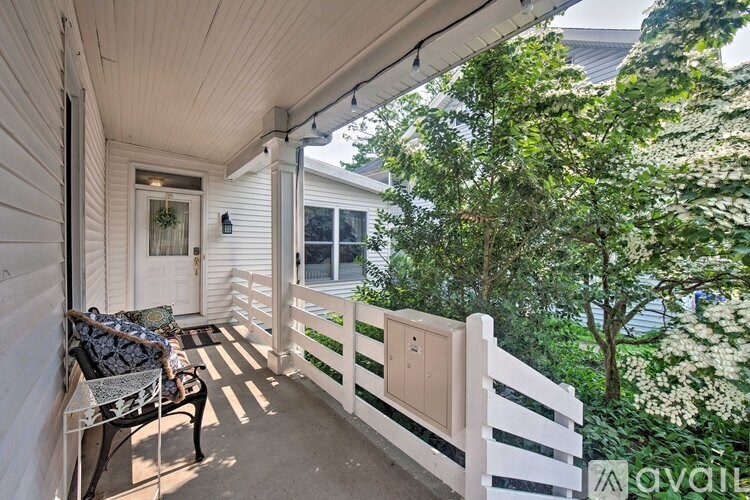 A balcony with a bench and a dog.