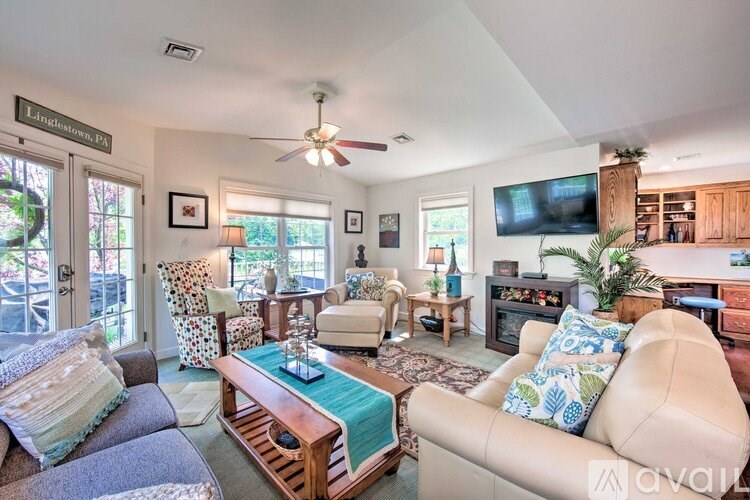 A living room with a couch, chairs, and a coffee table.