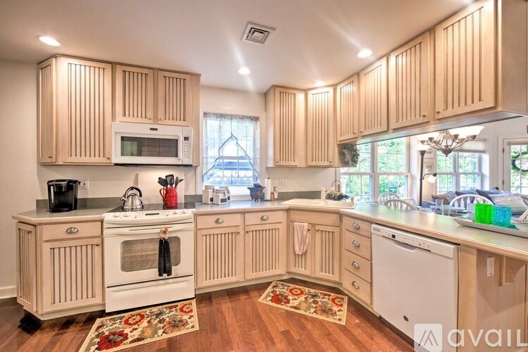 A kitchen with wooden cabinets and white appliances.