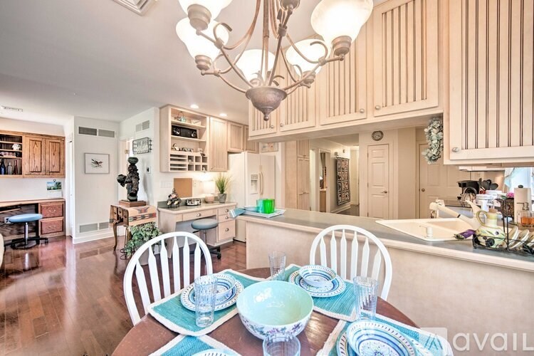 A dining room with a table set for two.