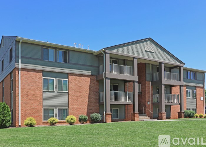 A large brick building with multiple balconies and windows.