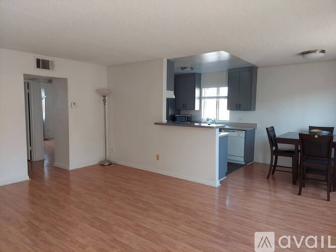 A kitchen area with a dining table and chairs.