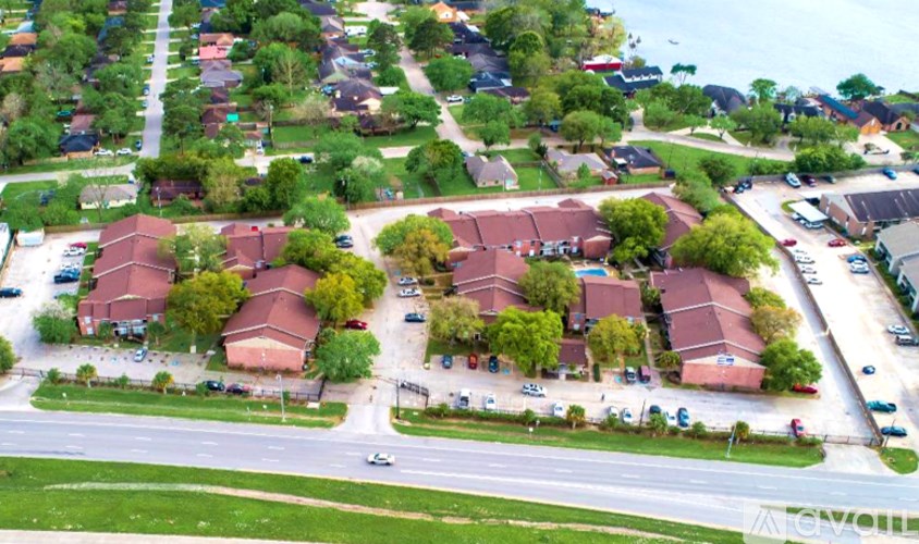 A suburban neighborhood with houses and parked cars.